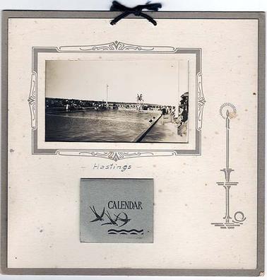 The photograph is of the opening of the Hastings swimming pool, which took place in November 1938. A memento has been made, with the photograph, decorative printed mounting, and a small printed calendar dated 1941