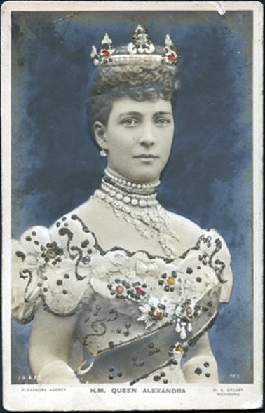 This image shows a colourized, embossed portrait of Queen Alexandra.  She is beautifully dressed and has jewels and brooches on her dress.  A wide sash is across her body.  She is wearing a crown on top of her curly hair, earrings and many necklaces.  The embossing on the photograph is picked out in glitter.  The background is coloured blue.  Printed on the bottom left-hand side of the photograph is “J.B. & Co” and on the opposite side is “760”.  Printed across the bottom on the mounting, left to right is: “Alexandra Agency” “H.M. Queen Alexandra” and W.S. Stuart Richmond”.