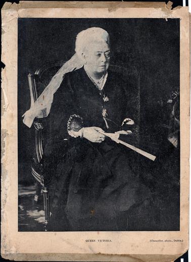 This is a full-length portrait of Queen Victoria which has been taken out of a magazine and glued onto cardboard.  She is dressed in black with a white veil.  She is holding a fan in her hands.  The following is printed at the bottom of the photo: “Queen Victoria (Chancellor, photo., Dublin.)”.