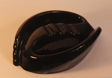 Pottery ashtray with black glaze; oblong shape.