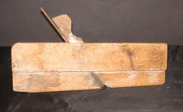 Oblong plane made of oak, used for making grooves in wood.