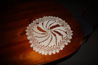 Round cotton crocheted table mat.
