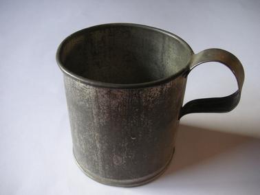 Handmade from jam tin with metal handle soldered on.