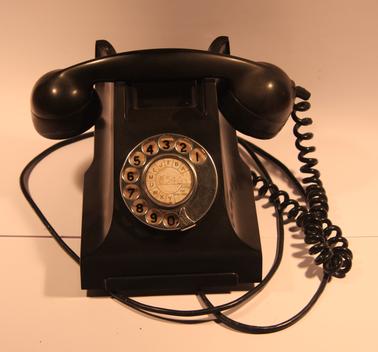 Heavy black telephone.  Rotary dial.  Standard in Australian homes from 1939.  Phone No: 8546