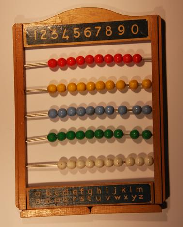 Abacus (counting frame).  5 rows of coloured beads set in wooden frame with numbers at top and alphabet at bottom.