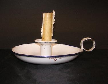 White enamel round candle holder with royal blue edging.  Round finger grip and central candle socket.  Unidentified marking under base.