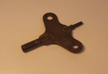 Brass key, probably a clock key.  Shaft of key has some circular grooving
