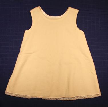 White baby handmade flannelette petticoat. Bias binding at armholes. Lace trim at bottom,