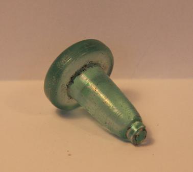 Glass stopper for glass bottle.  Blue/green in colour.
