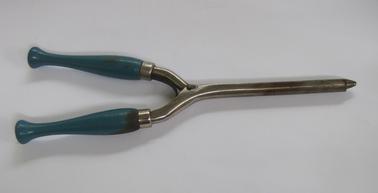 Metal curling iron - two pieces, pinned in the centre with a spring between the two pieces forming the hinge.  Blue wooden handles.  Heated on gas burner, opened and hair rolled over the circular rod.  Closed and held, then opened to release the curl.