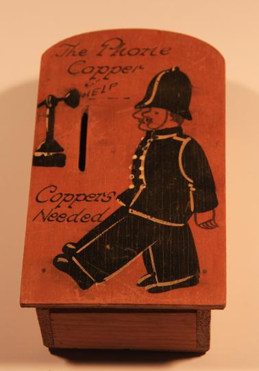 Wooden money box for telephone money.  “The Phone Copper - Help - Coppers Needed”.
Hand painted with old style phone and two policemen.
