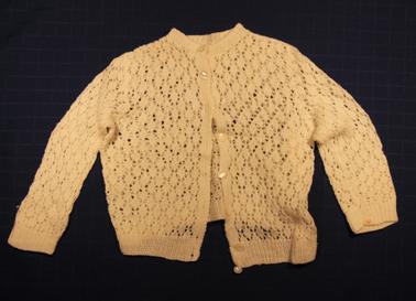 White hand knitted baby jacket.  8 pearl buttons at the front, long sleeves