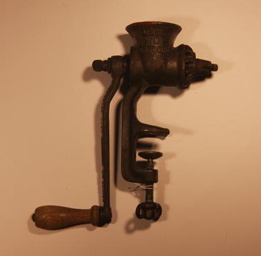 Cast metal five piece hand operated meat mincer, to fix to bench top with screw. Size 0