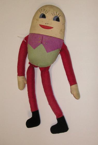 Hand made doll in the shape of “Humpty Dumpty”.  Red arms and legs, black feet.  Green body with pink waiscoat.  Facial features made from felt and stitched.