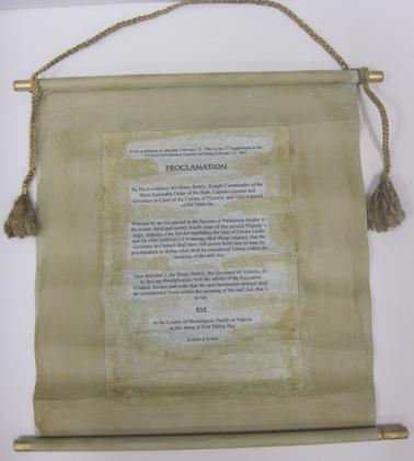 Document in the form of a scroll - used in 150th Celebrations of Rye Proclamation (20/2/2011).  Attached to wooden dowel at each end.  Rope with gold tassels for hanging.