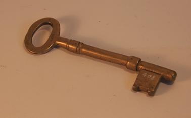 Brass key. Stamp ”MAKERS” on one side of handle.  Stamp “VICT.A..” on other side of handle. 