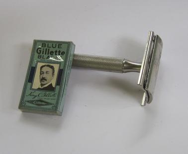 Safety razor breaks down into three pieces.  Handle screws into part that carries the blade. Original packet of five blades in blue packet.