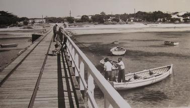 Rye pier looking South 1960's with fishermen on pier and in a boat