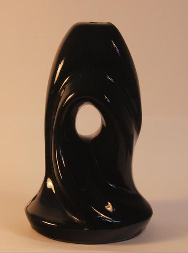 Ceramic lamp base with rounded base, twisted form, black glaze with hole in centre.