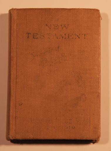 Small New Testament. Cardboard khaki coloured cover with black writing on front and back.