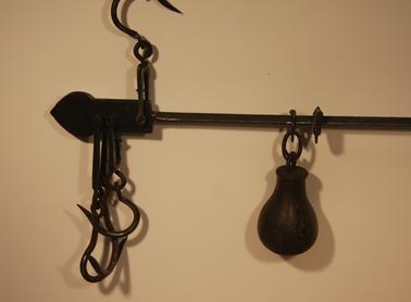 Straight beam balance with arms of unequal length used for weighing various items.  Model No 310