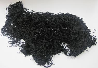 Black knotted shawl with fringe all around.  Icm square sections knotted at corners.  Widest across centre, narrow at each end to points.