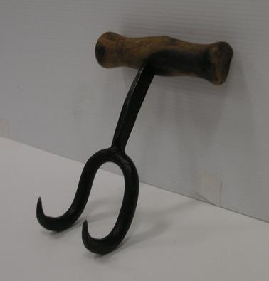 Bale hook - 2 steel hooks attached to wooden handle by one steel post.