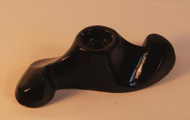 Pottery candle holder with black glaze.   Propeller shaped. 