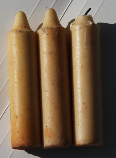 3 candles.  Dark cream coloured.