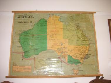 Wall Hanging.  Coloured map of Australia (No. 132) with small map of Papua New Guinea.  Wooden rods for rolling top and bottom.
