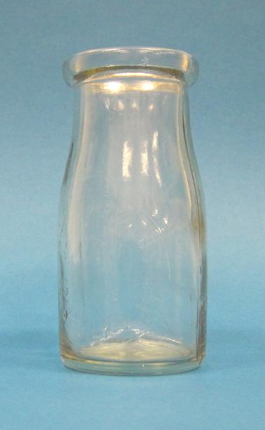 Clear glass cream bottle - “1/4 Imperial pint” stamped in glass.  Front side stamped “Please wash and return empty bottle”.  Other side of bottle stamped “This bottle property of Dairy Farmers Co-op Milk Co. Ltd.” 