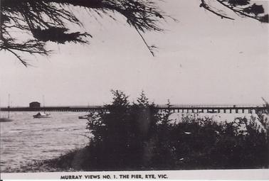 Rye Pier from  foreshore on west side
Shed at end of pier.   Couta boats in water.