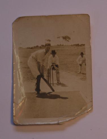 Alan Sullivan, left handed batsman, facing up to bowler (not visible).  Wicket keeper and first slip in photo also.