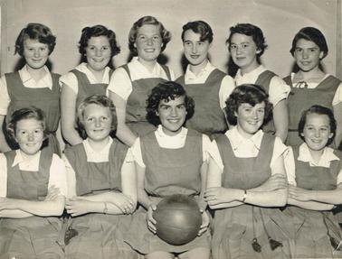 Photo of 11 girls girls taken inside hall.  Back row standing behind seated front row.  Girl centre front holding basketball.  Back row L-R : Isabel Newman, Bev Jenkin, 
gwenda Allison, Josie Cain, Joy Armstrong, Nola Harris.  Front row L_R : Eve Taylor, Gwen Culliver, Heather Armstrong, Margaret Myers, Janet Newman