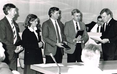 Swearing-in of a new councillors of Flinders Shire 1987.  Men in jacket and tie, lady in skirt with white blouse and dark jacket