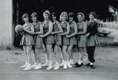 Black and white photograph of the 1962 Rye Basketball team. L-R:  Denise Reed, Ros Taylor, ? Greenwood, ? Greenwood, Sue Hill, Bev Hill, Joy May, Phil Clack.  Basketball Court, Rye Football Ground