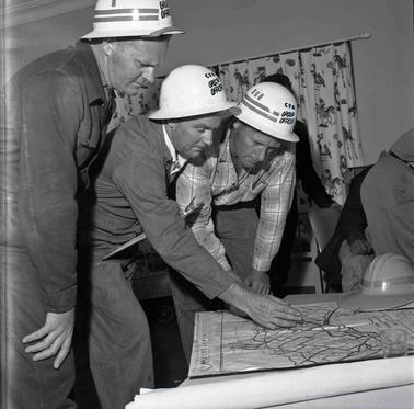 CFA area control group consulting over a map. 