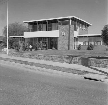 A two storey building with a clock.