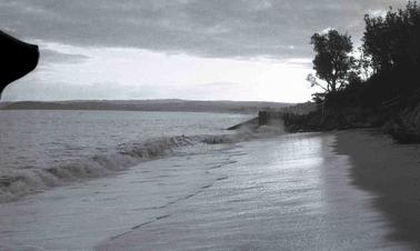 A private boat ramp under attack by rough sea waves.