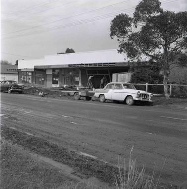 A view across a road to a shop construction scene.