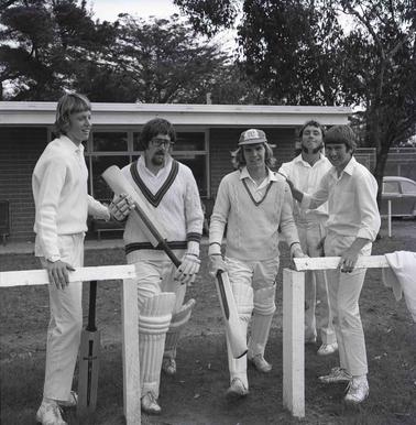 Group photo of five men dressed in cricket whites.