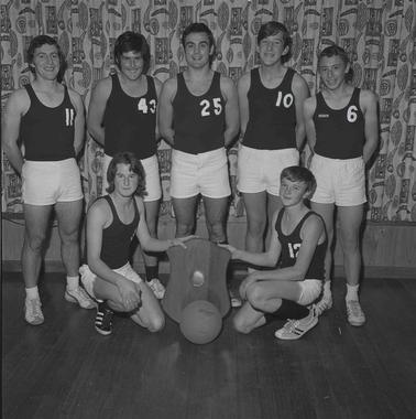 A team even young people in basketball uniform.