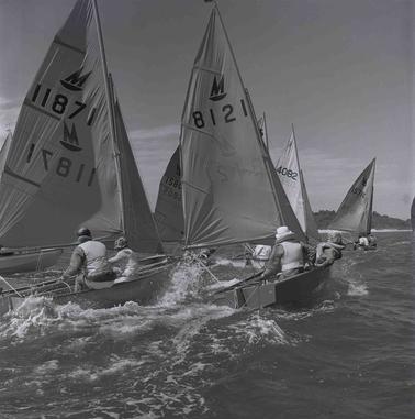 Yachts sailing away from the beach.