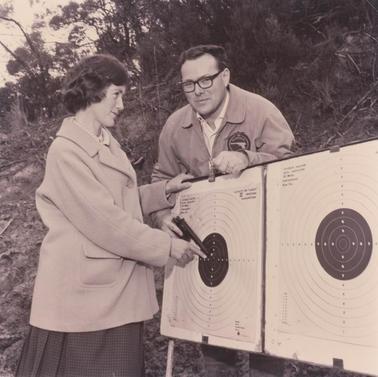 Man and woman checking targets.