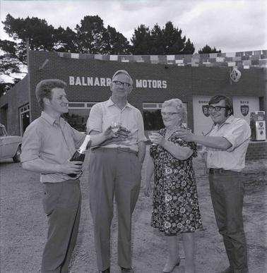 Four adults, (one female) raising glasses as they celebrate with Champagne.
