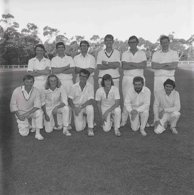 Group photo of twelve men dressed in cricket whites in two rows