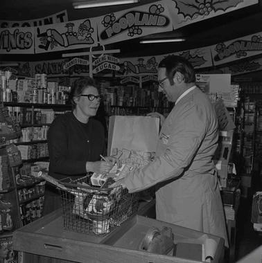 A woman and man in a grocery store.