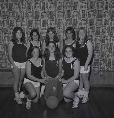 Basketball Team of seven girls posing for group photograph.
