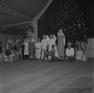 Children forming a Christmas tableau: Mary, Joseph, shepherds etc.