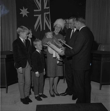 A couple with four children with an official.